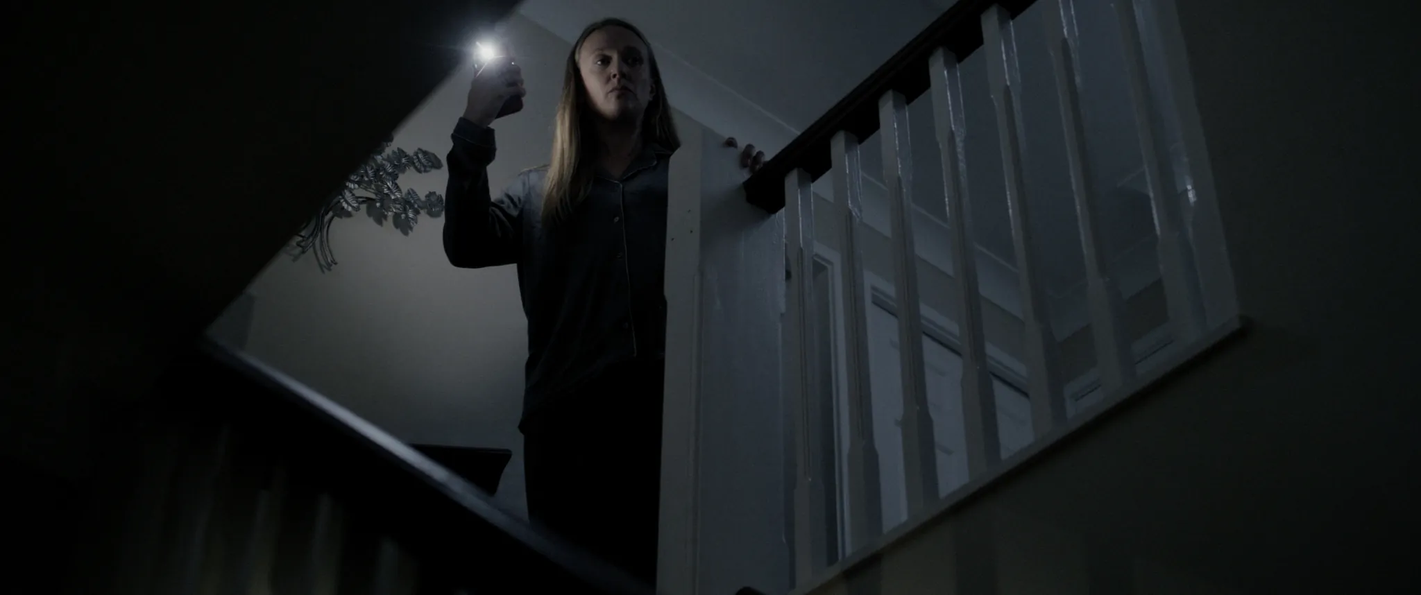 Emily Head climbs the stairs by torchlight
