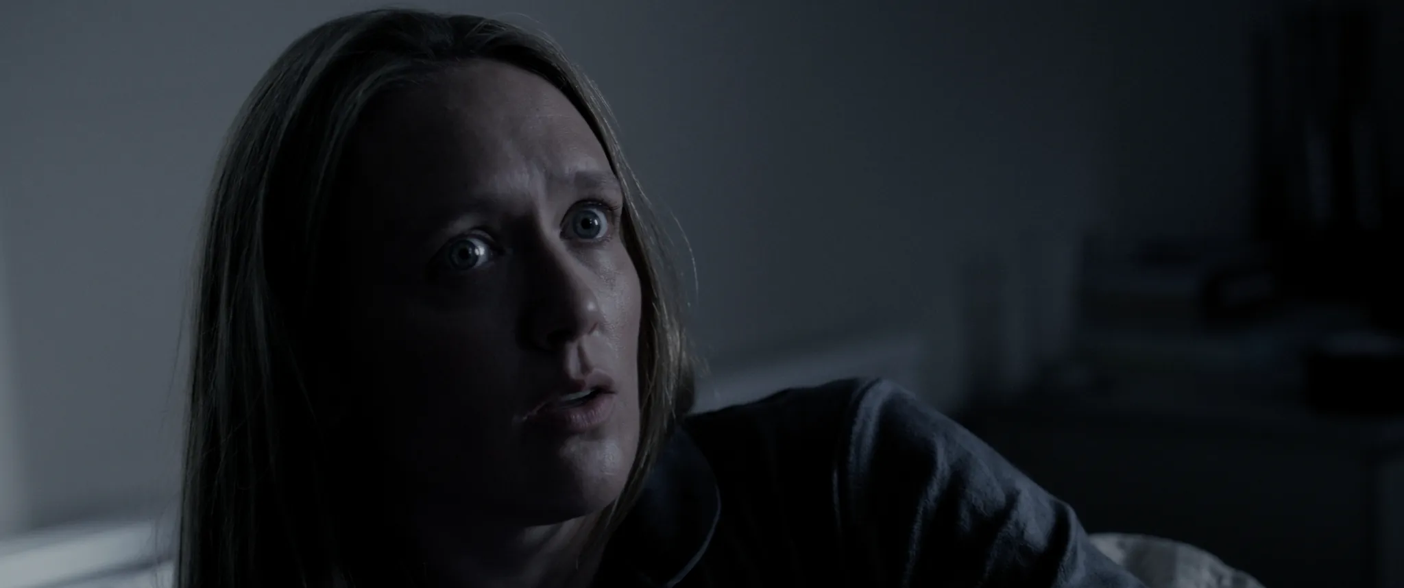 Emily Head, frozen, listening in the dark